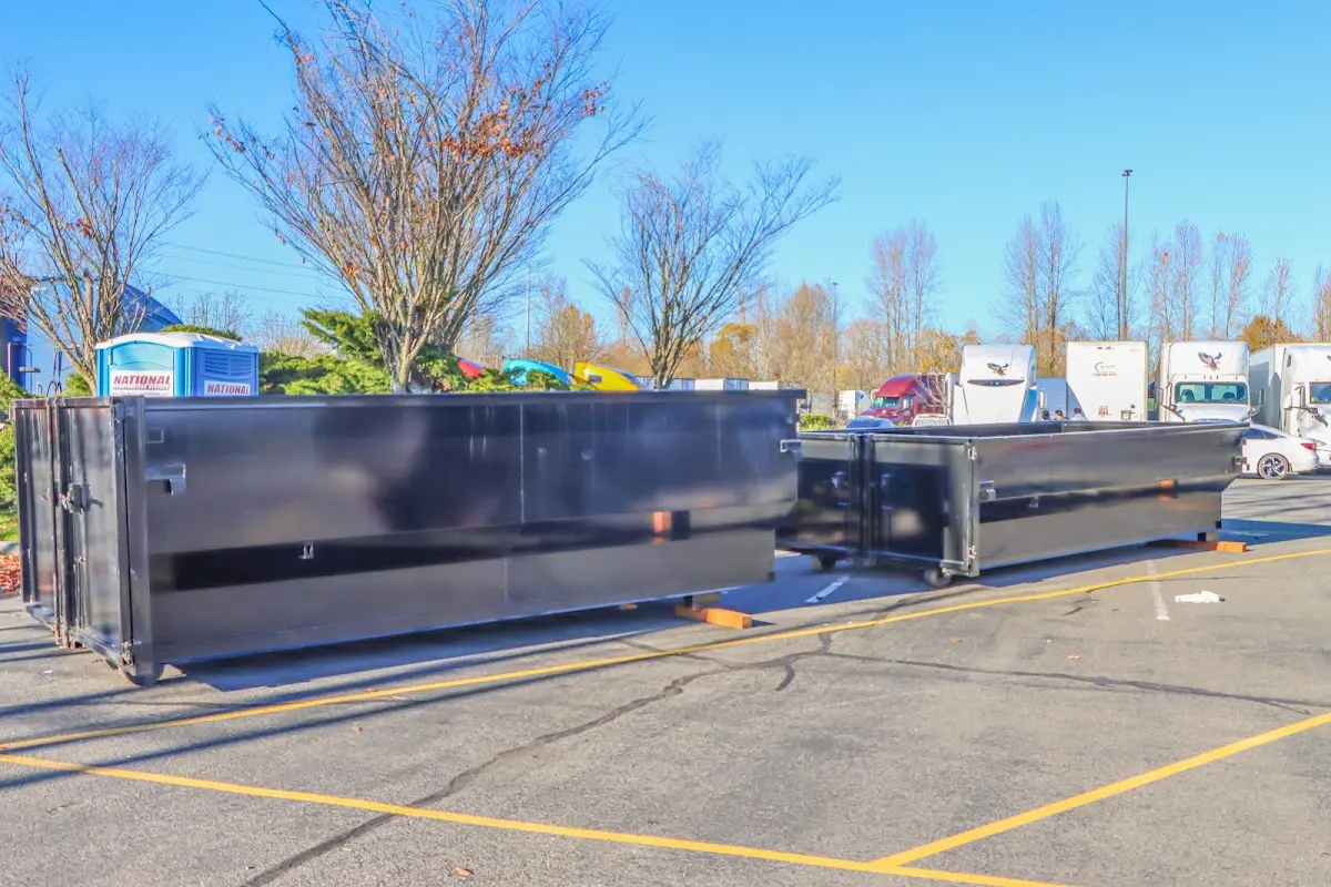 Professional dumpster rental service with roll-off container on residential driveway in Miles City